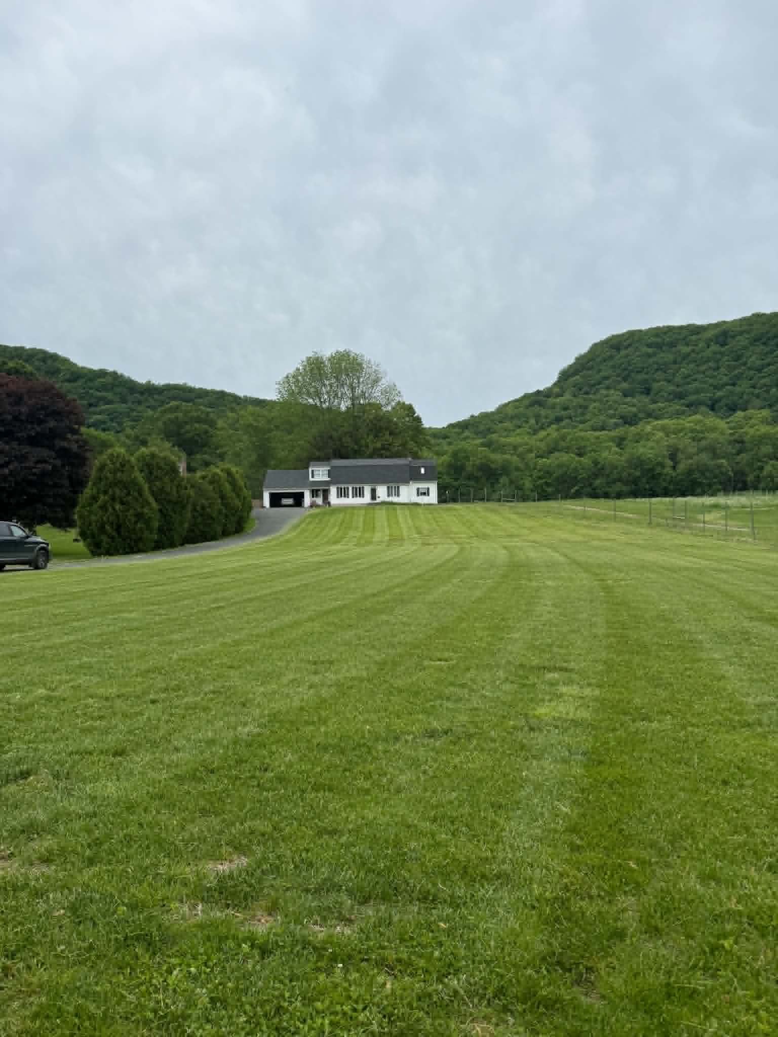 Wide freshly mowed lawn leading toward a home